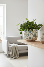Bloom white ceramic planter with blue floral embossed relief on wooden shelf