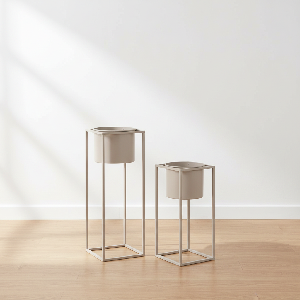 Set of two beige grey steel Marla plant stands empty on oak floor with soft daylight and clean background