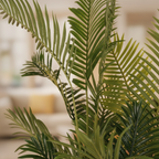 Close-up of artificial Areca palm feathery green fronds and leaflets with soft warm backlight