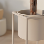 Close-up of beige grey steel Marla plant stand open square frame and cylindrical pot insert