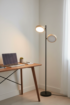 Tessa almond LED floor lamp in home office corner beside wooden desk with laptop