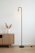 Modo black minimalist floor lamp in living room corner beside wooden sideboard