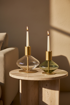 Lumis Duo candle holders on travertine side table, lit candles, afternoon light
