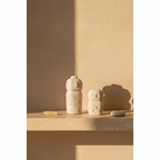 Arden Beige Cement Decorative Piece on travertine shelf