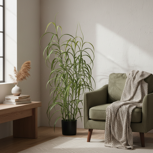 Tall artificial grass plant beside a reading chair in a warm Nordic interior with soft natural light
