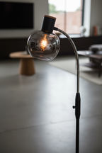Close-up of Fumoso smoked glass globe shade with warm light glowing through