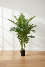 Large realistic artificial Areca palm on oak floor with soft daylight and clean off-white background, full height visible