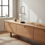 Lucena black metal ribbed glass lantern on a sideboard in a Nordic interior with dried botanical styling