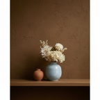 Azure Bloom Light Blue Ceramic Vase on oak shelf with dark limewash wall