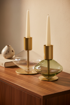 Lumis Duo candle holders close-up on walnut sideboard, green glass detail