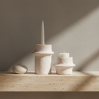 Cemina cement candle holders on travertine console, concrete wall, straight-on