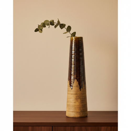 Earthline brown ceramic vase close-up on walnut sideboard, textured relief detail