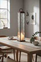 Herslev tall antique brass glass lantern as centrepiece on a Scandinavian dining table with warm candlelight