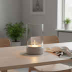Grey ceramic and glass hurricane candle holder as centrepiece on a Scandinavian dining table with warm candlelight