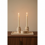 Luma travertine tealight holder set close-up on walnut sideboard, warm candlelight