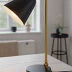Triton lamp close-up detail of brass arm joint and black conical shade