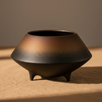 Close-up of the bronze-to-black mineral glaze surface of the Otaru S ceramic bowl
