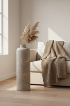 Tall antique beige metal Hou floor vase with textured surface styled in a Scandinavian living room corner