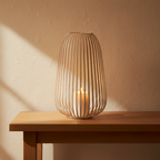 Stoense beige metal open cage lantern on oak console, limewash wall, candle glow