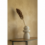 Segura beige stoneware sculptural vase on oak console, dried stem, limewash wall