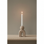 Bello stoneware candle holder on travertine shelf, concrete wall