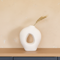 Lumira White Ceramic Sculptural Vase on oak shelf with limewash wall