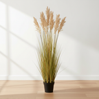 Tall artificial sorghum grass plant on oak floor with soft daylight and clean off-white background