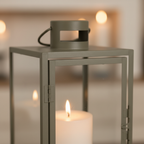 Close-up of Corfu green steel frame and glass panel with warm candlelight glow inside